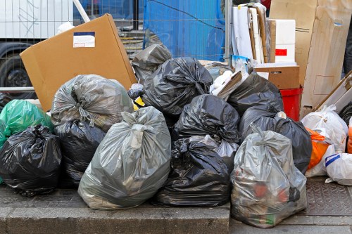 Front view of commercial waste trucks parked in Kensington street with staff preparing bins
